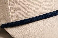 Navy rope detail on a cream hat brim